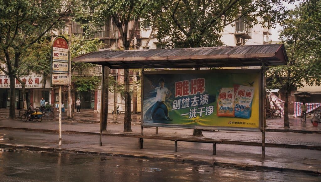 老式公交站亭，铁皮顶棚，站牌与长椅，怀旧写实风格