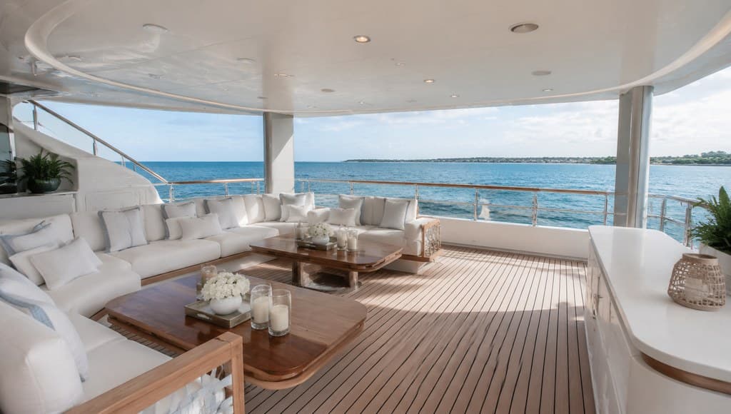 yacht deck interior lounge area with plush white seating and ocean views