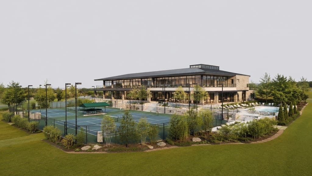 tennis club and spa exterior with courts visible beside a modern clubhouse