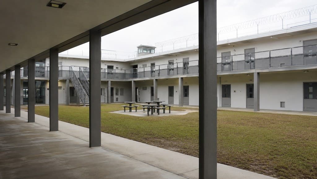 prison yard common area interior view from a covered walkway