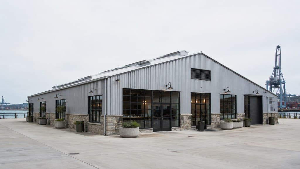 dockside warehouse exterior with corrugated metal walls beside a shipping port